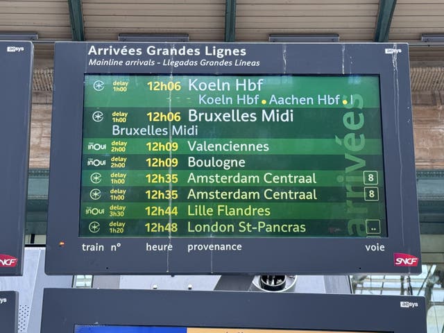 A screen at Gare Du Nord shows delayed trains