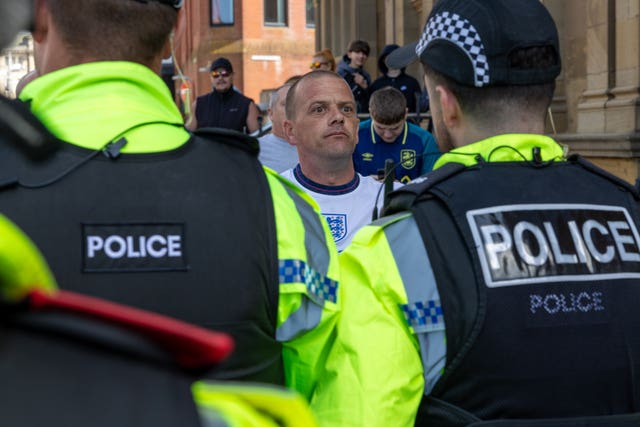 A man stands in front of police