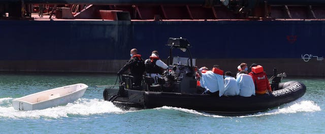 A Border Force vessel brings a group of men thought to be migrants into Dover, Kent (Gareth Fuller/PA)
