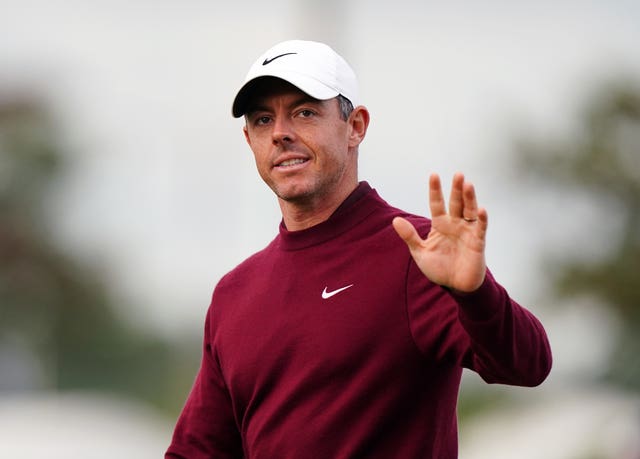 Rory McIlroy waves to the crowd during a golf tournament