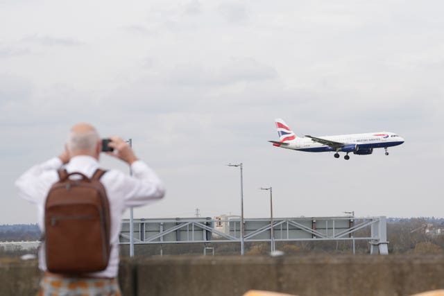 A planespotter watching a flight at Heathrow