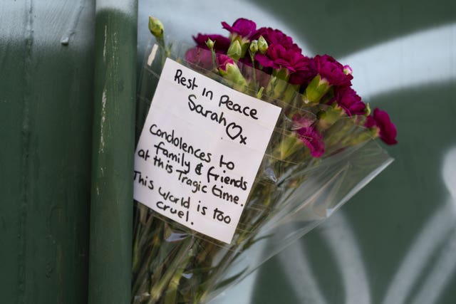 Bunch of flowers with a written tribute to Sarah Mayhew