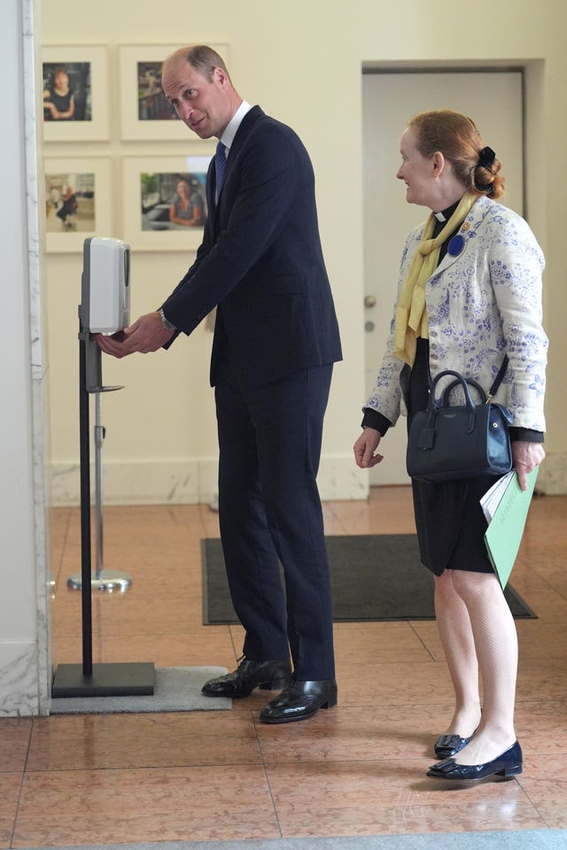 The Prince of Wales using a hand sanitiser dispenser as he arrives at an event at the Royal Society
