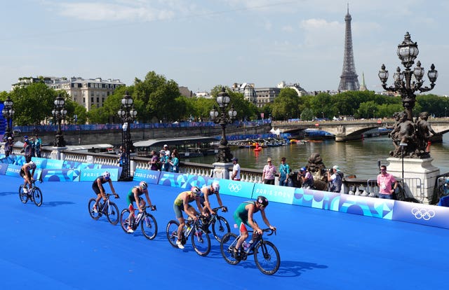 Great Britain’s Alex Yee, left, was part of a big group on the bike 