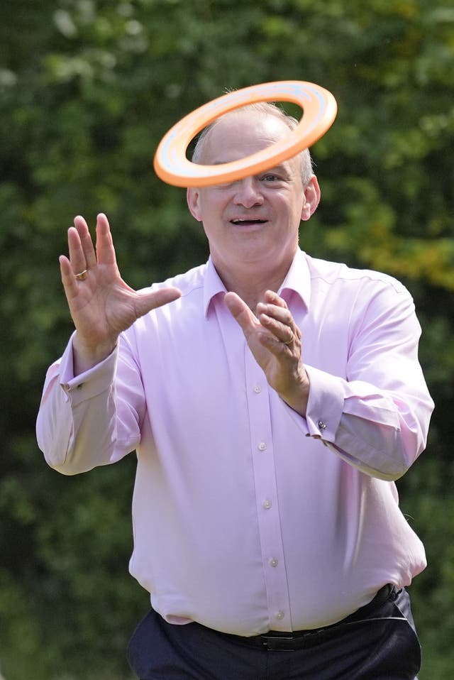 Liberal Democrats leader Sir Ed Davey plays with a frisbee 