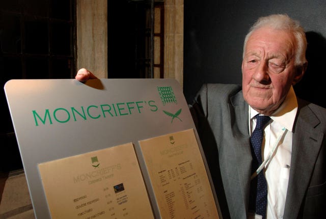 Chris Moncrieff with the menu of Moncrieff’s bar