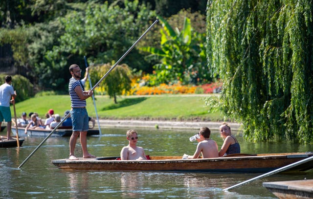 People punt along the River Cam in Cambridge 