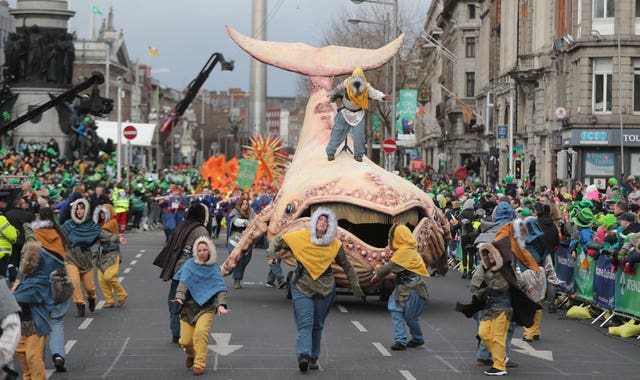 Thousands watch as a St Patrick's Day float drives by