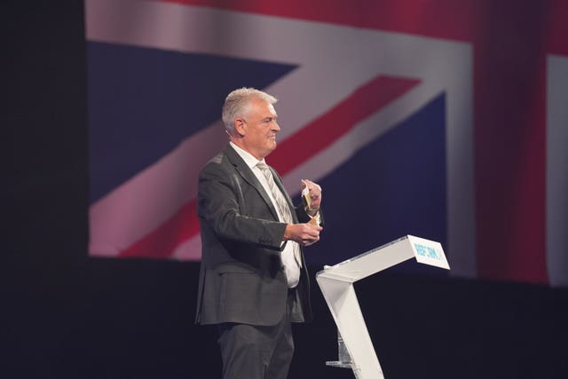 Reform UK MP Lee Anderson tears up his TV licence as he speaks at the party’s annual conference at the National Exhibition Centre in Birmingham