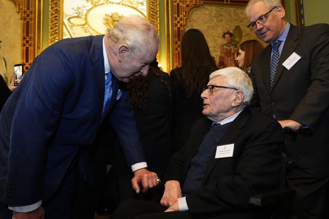 The King shakes hands with survivor Max Snijders 