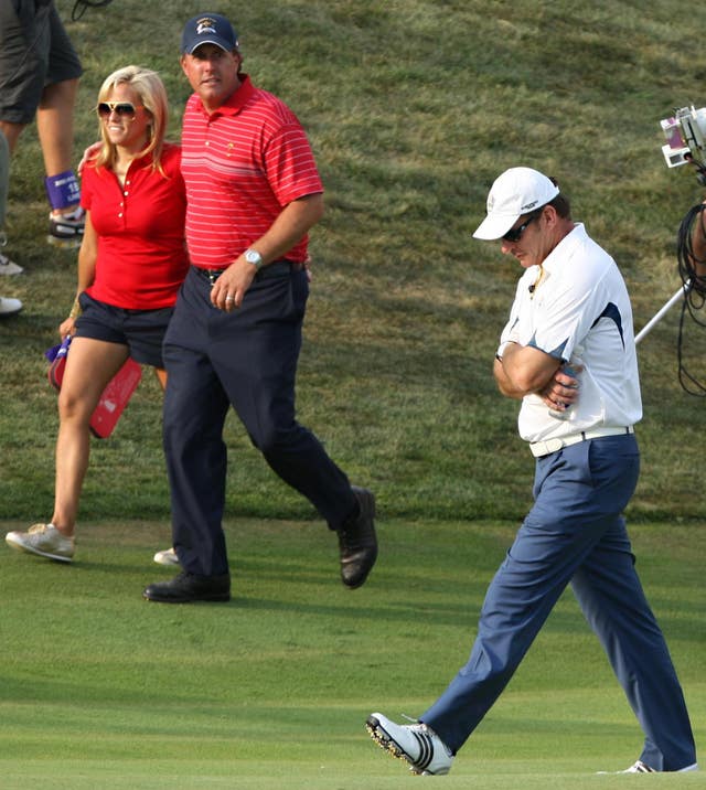 A dejected Nick Faldo accepts defeat, with Phil Mickelson looking on