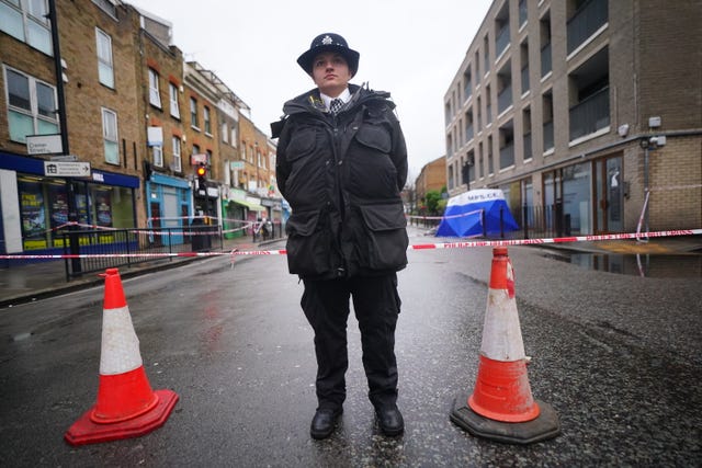 A police officer in Shoreditch near the scene where a 17-year-old boy has died after being stabbed
