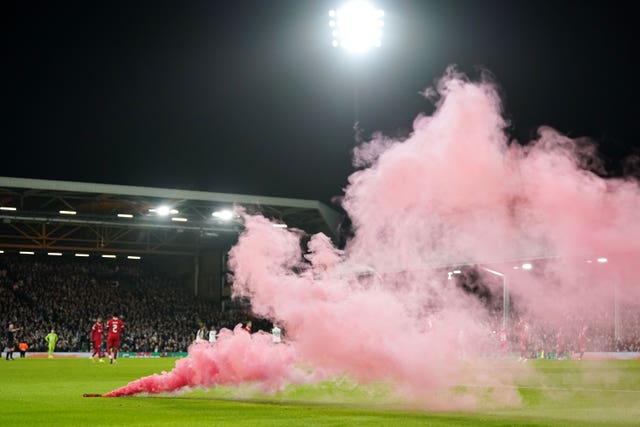 A smoke flare was thrown on to the pitch after Liverpool''s goal