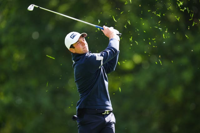 Viktor Hovland hits an iron during his first round