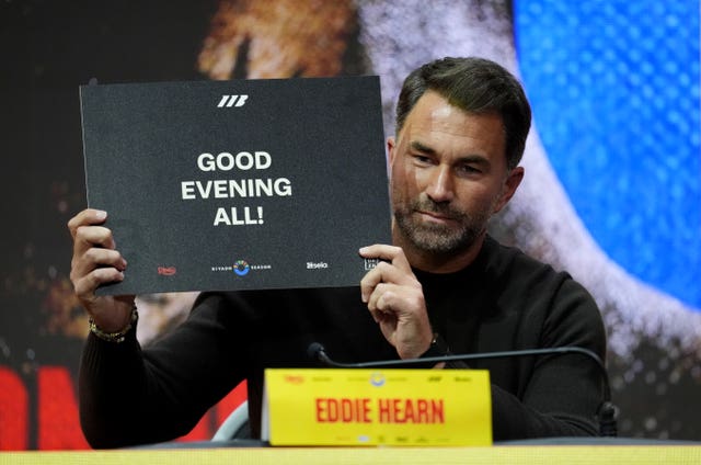 Eddie Hearn holding up a sign instead of speaking