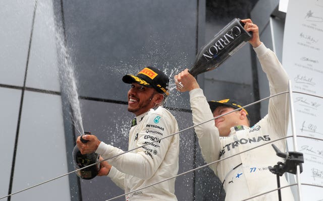 Lewis Hamilton, pictured celebrating victory with Mercedes team-mate Valtteri Bottas, whom he must outscore by 14 points in Mexico to clinch a sixth world title