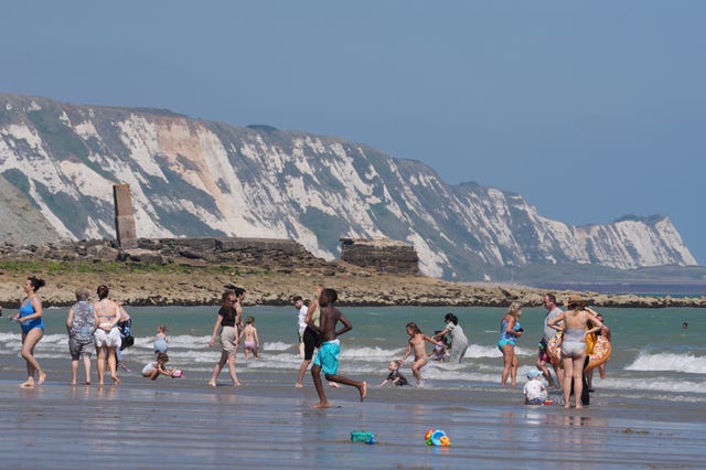 People enjoy the hot weather on Sunny Sands beach in Folkestone, Kent, on Saturday.