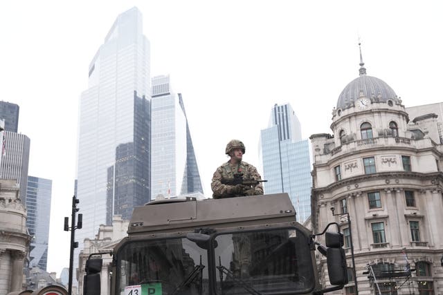 A soldiers sits on the top of a tank during the Lord Mayor’s Show 2024