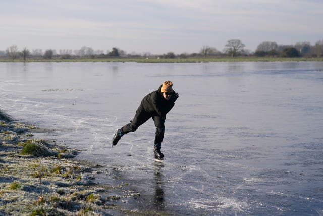 A man skates on a frozen field