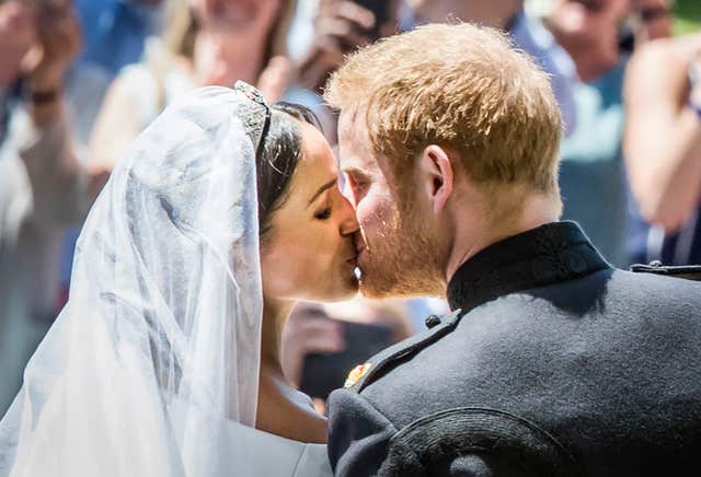 Sealed with a kiss: Harry and Meghan on the the steps of St George’s Chapel (Danny Lawson/PA)