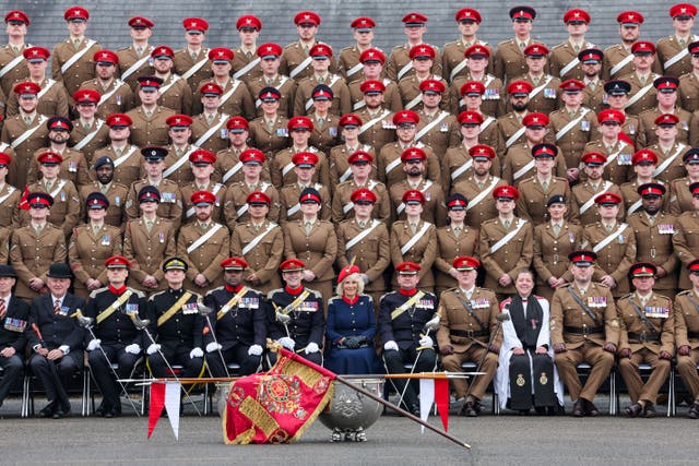Queen Camilla poses for a group photograph with The Royal Lancers during her to visit to the Royal Lancers regiment, her first visit to the regiment since being appointed as their Colonel-in-Chief, at Munster Barracks, Catterick Garrison, North Yorkshire