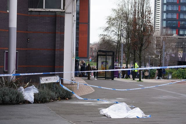 Police tape cordoning off an area outside a building
