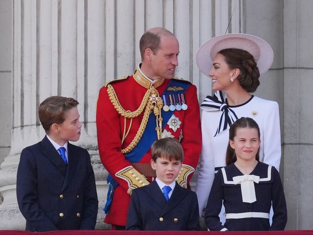 William and Kate look at one another on the Palace balcony during the Trooping the Colour celebrations as they are joined by their children George, Louis and Charlotte