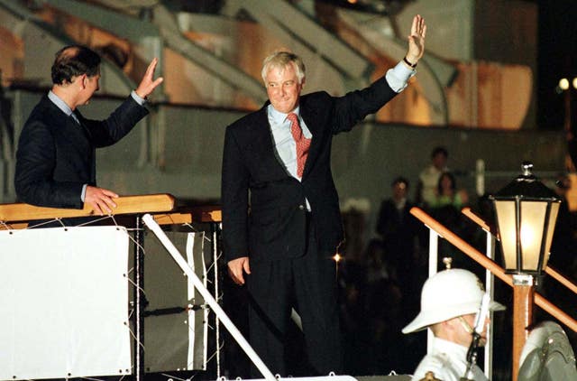 Chris Patten, the last governor of Hong Kong, and the then-Prince of Wales wave from the Royal Yacht Britannia as they prepare to leave Hong Kong in 1997
