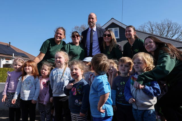 Prince of Wales posing with students