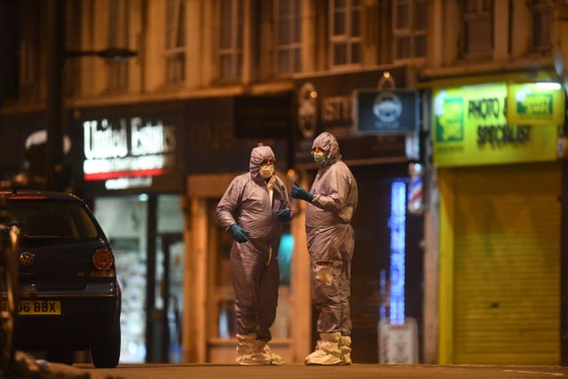Police forensic officers works at the scene in Streatham High Road, south London