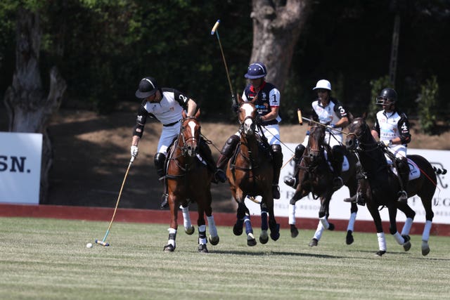 The Duke of Sussex (left) takes part in the match