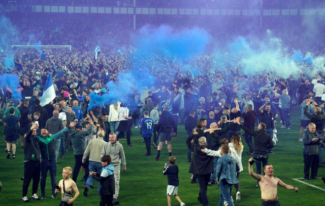Everton fans celebrate on the pitch (Peter Byrne/PA)