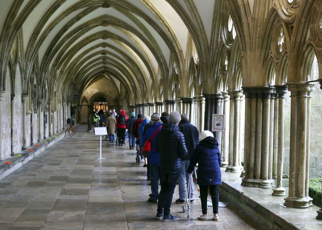 People queue outside Salisbury Cathedral, Wiltshire, to receive a jab (Steve Parsons/PA)