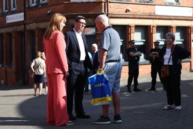 Prime Minister Andy Burnham talks with members of the public during a visit to a town centre 