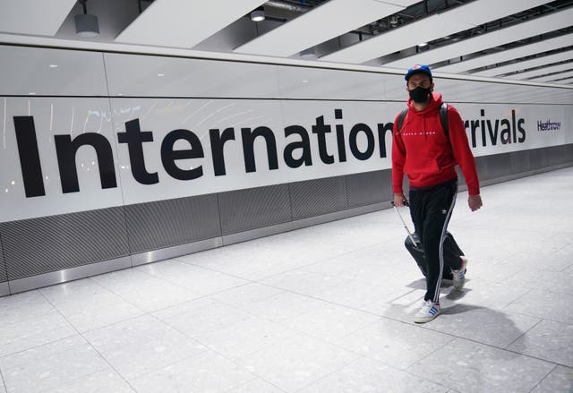 A passenger passing a sign reading 'International arrivals'