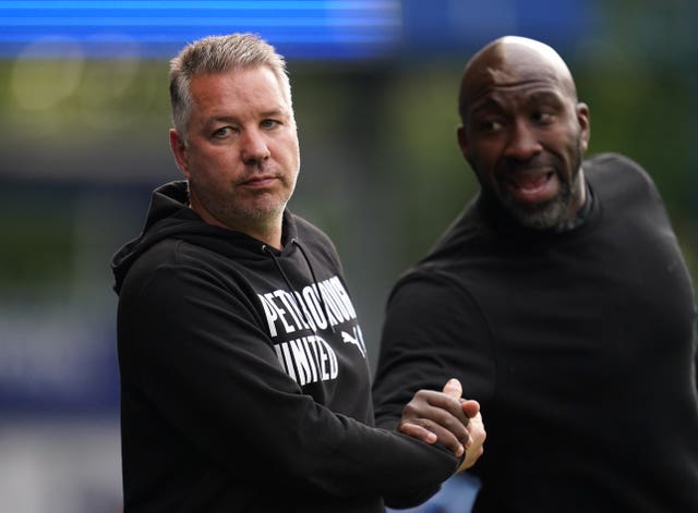 Sheffield Wednesday manager Darren Moore (right) and Peterborough United manager Darren Ferguson during the Sky Bet League One play-off semi-final second leg match at Hillsborough, Sheffield