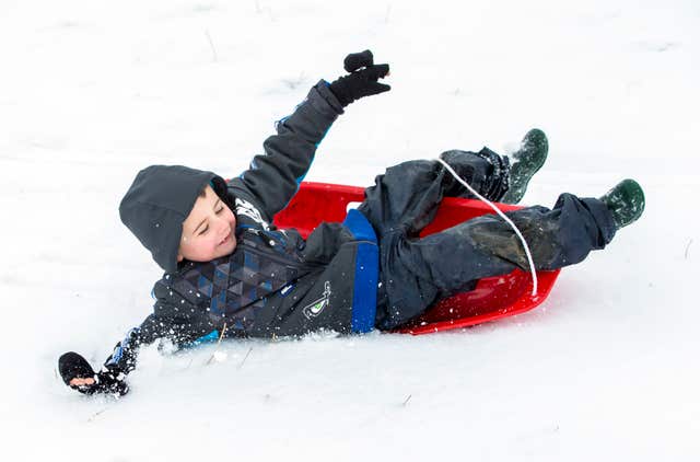 Alfie Astwood sledging in the snow near Reeth (Danny Lawson/PA)