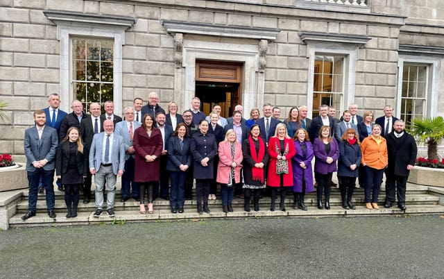 Mary Lou McDonald and Michelle O’Neill with Sinn Fein’s TDs outside Leinster House in Dublin