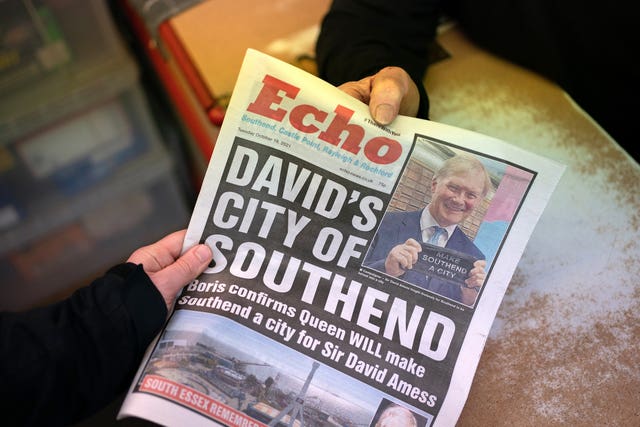 Newsagent Len Quinn sells a copy of the Southend Echo at his shop in Southend-on-Sea in Essex 