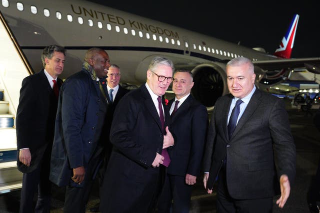 Prime Minister Sir Keir Starmer (centre), Foreign Secretary David Lammy (second left) and Energy Secretary Ed Miliband (left) arrive at Heydar Aliyev International Airport  (Carl Court/PA)