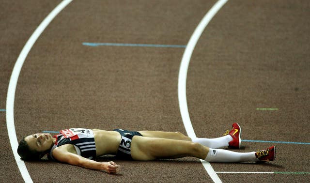 Jo Pavey lies on the track after finishing fourth in Osaka