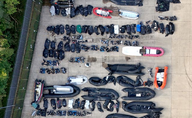 Boats used by migrants lined up in a storage facility