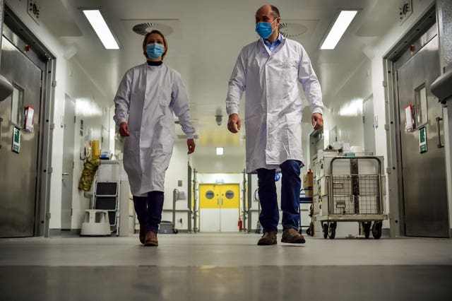 Scientists walk down corridor