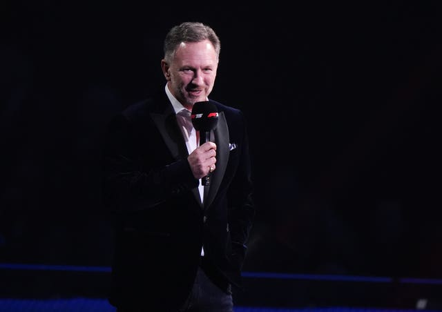 Red Bull team principal Christian Horner speaks into a microphone and addresses the crowd at the O2 in London