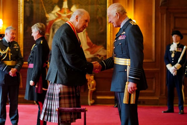 Sir Alexander McCall Smith shaking hands with the King