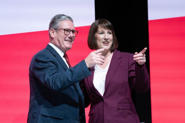 Keir Starmer and Rachel Reeves point to the audience while on stage at the 2024 Labour Party conference