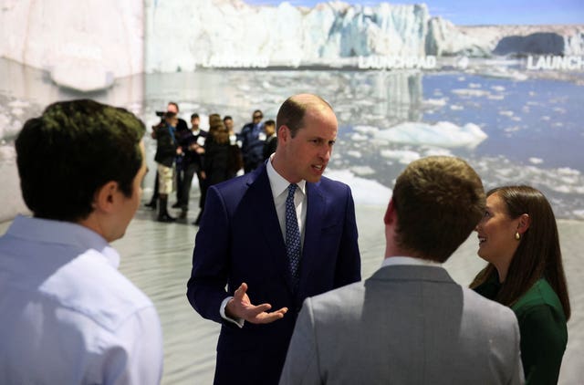 William speaking with guests at the event