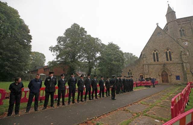 Emergency services personnel line up outside St Paul’s Church