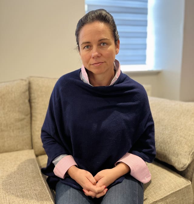 Zoe Turnbull seated on a sofa, looking into the camera