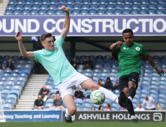 Grenfell AFC player Caleb Backer (right), shoots during a match against South London FC